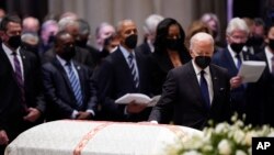 U.S. President Joe Biden places his hand on the casket of former Secretary of State Madeleine Albright during her funeral service at the Washington National Cathedral, in Washington, April 27, 2022.