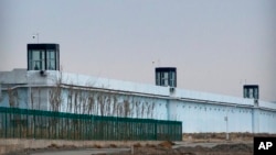 FILE - A person stands in a tower on the perimeter of the No. 3 Detention Center in Dabancheng in western China's Xinjiang Uyghur Autonomous Region on April 23, 2021. 