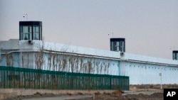FILE - A person stands in a tower on the perimeter of the No. 3 Detention Center in Dabancheng in western China's Xinjiang Uyghur Autonomous Region on April 23, 2021. Human rights groups and Western nations have accused China of massive crimes against the Uyghur minority.