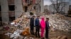 Residents look at their house destroyed by a Russian bomb in Chernihiv on April 22, 2022. 
