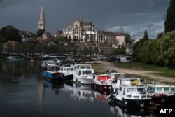 FILE - The river Yonne and the Abbey of Saint-Germain d'Auxerre are seen in Auxerre, France, May 13, 2021.