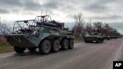 FILE - A Russian military convoy moves on a highway in an area controlled by Russian-backed separatist forces near Mariupol, Ukraine, April 16, 2022. Moscow intends to seize all of southern and eastern Ukraine, a Russian general said on April 22, 2023. 