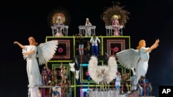 Dancers from the Unidos da Vila Maria samba school perform on a float during a carnival parade in Sao Paulo, Brazil, April 23, 2022. 