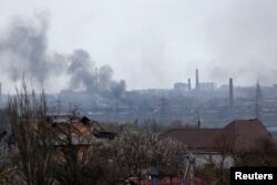 Asap mengepul di atas pabrik Besi dan Baja Azovstal saat konflik Ukraina-Rusia di kota pelabuhan selatan Mariupol, Ukraina, 21 April 2022. (REUTERS/Alexander Ermochenko)