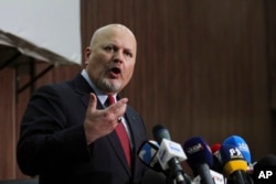 FILE - Karim Khan, International Criminal Court chief prosecutor, speaks during a news conference in Khartoum, Sudan, Aug. 12, 2021.