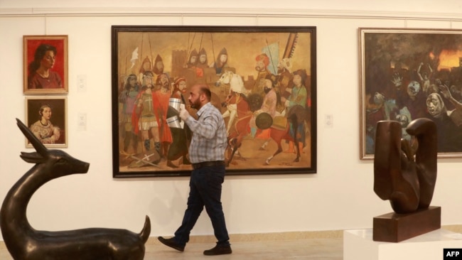 Restored art pieces by renowned Iraqi artists are on display at Iraq's Ministry of Culture in Baghdad on April 6, 2022.