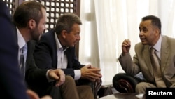 Peter Maurer, center, president of the International Committee of the Red Cross, listens to Hamid al-Awadhi, right, undersecretary of Yemen's Foreign Ministry, upon arrival at the international airport of Yemen's capital, Sana'a, August 8, 2015.