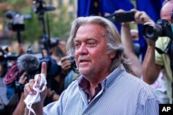 FILE - President Donald Trump's former chief strategist Steve Bannon speaks with reporters in New York, Aug. 20, 2020.