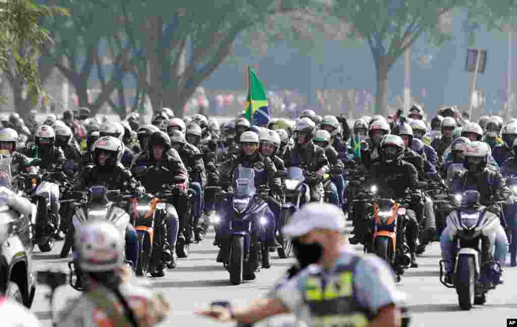 Brazil&#39;s President Jair Bolsonaro, center, takes part in a caravan of motorcycle enthusiasts in Sao Paulo, Brazil, June 12, 2021.