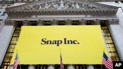 A banner for Snap Inc. hangs from the front of the New York Stock Exchange, March 2, 2017, in New York. 