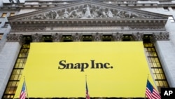 A banner for Snap Inc. hangs from the front of the New York Stock Exchange, March 2, 2017, in New York. 