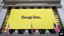 A banner for Snap Inc. hangs from the front of the New York Stock Exchange, March 2, 2017, in New York. 