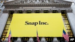 A banner for Snap Inc. hangs from the front of the New York Stock Exchange, March 2, 2017, in New York. 