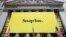 A banner for Snap Inc. hangs from the front of the New York Stock Exchange, March 2, 2017, in New York. 