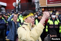 People protest outside parliament while Taiwanese lawmakers vote on the third reading of amendments to the Civil Servants Election and Recall Act and other controversial bills at the Legislative Yuan in Taipei on Dec. 20, 2024.