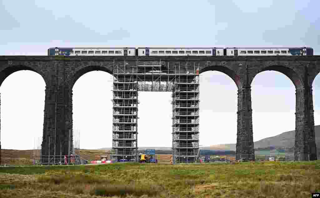 Workers erect scaffolding ahead of planned restoration work on the Ribblehead Viaduct, near Settle, northwest England.