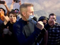 FILE - Mayor Ted Wheeler speaks to people gathered in downtown Portland, Ore., July 22, 2020.