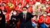 South Korean President-elect Yoon Suk-yeol holds bouquets as he is congratulated on his win by his party's members and lawmakers at the National Assembly in Seoul, South Korea, March 10, 2022. 