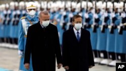 Turkish President Recep Tayyip Erdogan, left, and Israel's President Isaac Herzog inspect a military guard of honor during a welcome ceremony, in Ankara, Turkey, March 9, 2022.