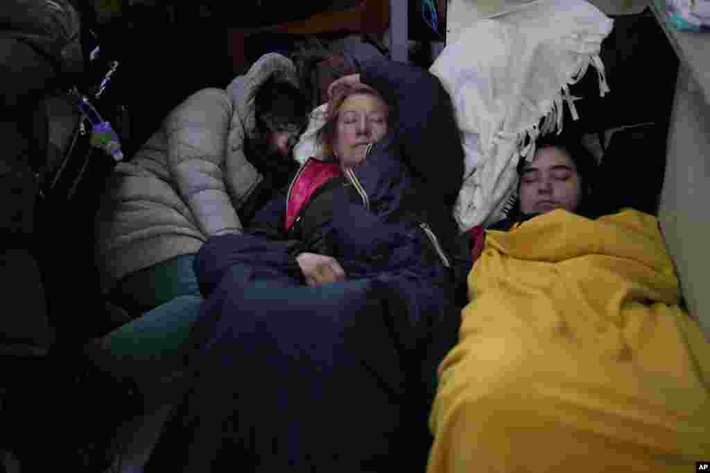 People who fled the war from neighboring Ukraine sleep at the Przemysl train station in Przemysl, Poland, March 9, 2022.