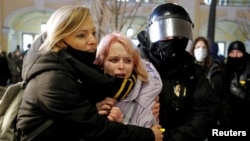 A Russian law enforcement officer detains demonstrators during an anti-war protest against Russia's invasion of Ukraine, in Saint Petersburg, Russia March 2, 2022. (REUTERS)