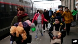 Ukrainian refugees arrive at Hendaye train station, southwestern France, March 9, 2022. About 200 Ukrainian refugees are arriving in that town of Hendaye, where local authorities are greeting them in the train station and offering them temporary lodging.