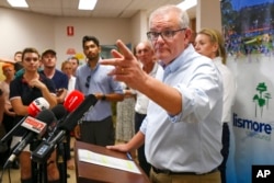 FILE - Australian Prime Minister Scott Morrison gestures during a press conference in Lismore, Australia, March 9, 2022.