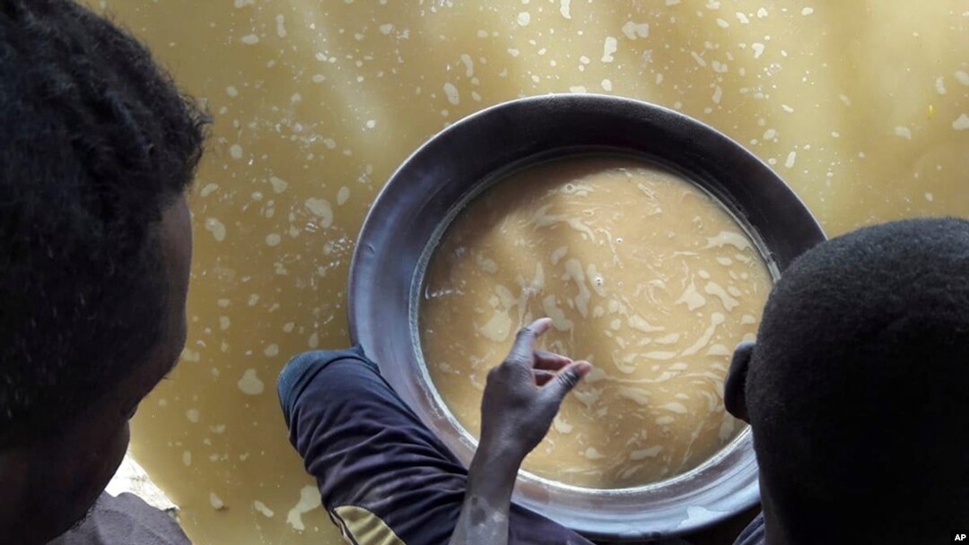 FILE - This handout photo taken on Aug. 31, 2018 in Sudan and provided by Interpol on Sept, 10, 2018, shows a gold mine where children use chemical products like mercury and cyanide, near Khartoum and the city's international airport.