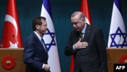 Israeli President Isaac Herzog, left, stands next to his Turkish counterpart Tayyip Erdogan after a press conference in Ankara, on March 9, 2022.
