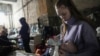 A young woman feeds a baby in a makeshift bomb shelter in Mariupol, Ukraine, March 7, 2022.