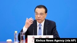 Perdana Menteri China Li Keqiang dalam konferensi pers setelah sesi penutupan Kongres Rakyat Nasional di Aula Besar Rakyat China di Beijing, 11 Maret 2022. (Ding Haitao/Xinhua via AP)