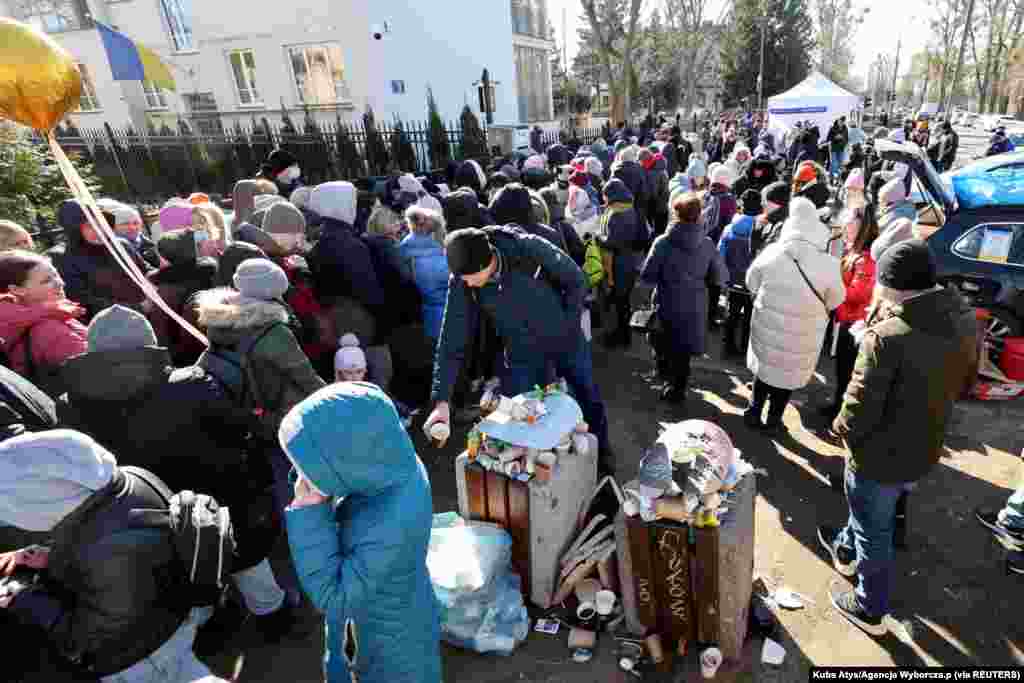 Refugees gather in front of the Ukrainian consulate in Warsaw, Poland, March 10, 2022.