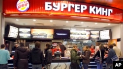 FILE - Customers line up at a Burger King outlet in a shopping mall in Moscow, Jan. 25, 2010. 