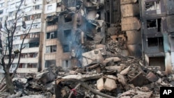 An apartment building is seen damaged after shelling in Kharkiv, Ukraine, Tuesday, March 8, 2022.