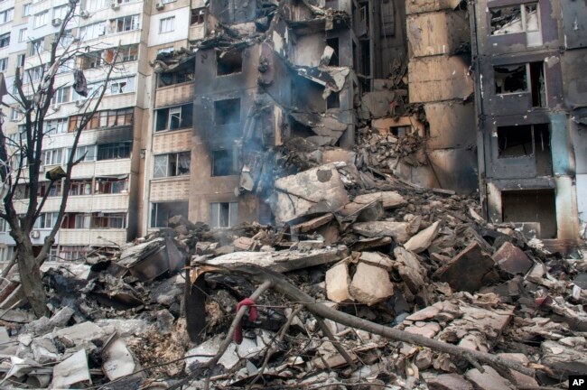 An apartment building is seen damaged after shelling in Kharkiv, Ukraine, Tuesday, March 8, 2022. (AP Photo/Andrew Marienko)