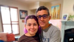 Gustavo Cardenas, one of six oil executives jailed in Venezuela, poses for a photo with his daughter Maria Mercedes, in their home in Houston, March 9, 2022, in this handout photo provided by Maria Elena Cardenas via AP. 