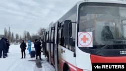 Buses wait during evacuations amid the Russian invasion of Ukraine, out of Sumy, March 8, 2022 in this still image obtained from handout video.