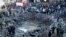 FILE - Rescue workers and soldiers stand around a massive crater after a bomb attack that tore through the motorcade of then-Prime Minister Rafik Hariri, in Beirut, Lebanon, Feb. 14, 2005.