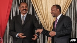 FILE - Eritrea's President Isaias Afwerki, left, and Ethiopia's Prime Minister Abiy Ahmed talk during the inauguration of the Tibebe Ghion Specialized Hospital in Bahir Dar, northern Ethiopia, Nov. 10, 2018.