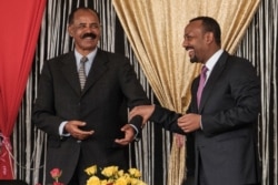 FILE - Eritrea's President Isaias Afwerki, left, and Ethiopia's Prime Minister Abiy Ahmed talk during the inauguration of the Tibebe Ghion Specialized Hospital in Bahir Dar, northern Ethiopia, Nov. 10, 2018.