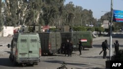 FILE - Egyptian riot policemen surround the entrance of al-Azhar university, in Cairo's eastern Nasr City district. The university is a popular destination for religious study among China's Muslims, many of whom attend the prestigious school in Cairo, the seat of Sunni Islam.
