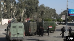 FILE - Egyptian riot policemen surround the entrance of al-Azhar university.