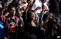 FILE - Students cheer while listening to members of the black student protest group Concerned Student 1950 on Nov. 9, 2015.