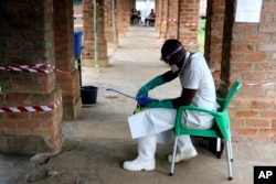A health care worker wears virus protective gear at a treatment center in Bikoro, Democratic Republic of Congo, May 13, 2018.