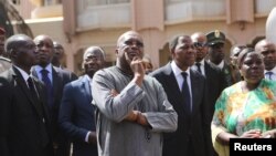 Le président du Burkina, Faso Roch Marc Christian Kaboré, au centre, et son homologue du Bénin, Thomas Boni Yayi (à sa droite) visitent lieu de l'attaque jihadiste qui a causé la mort de 30 personnes, à l’Hôtel Splendid, à Ouagadougou, Burkina Faso, 18 janvier 2016.