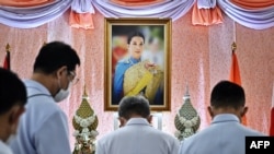 Well-wishers bow in front of an image of Thailand's Princess Bajrakitiyabha Narendira Debyavati, at Chulalongkorn Hospital in Bangkok, Dec. 16, 2022.