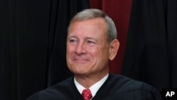 FILE - Chief Justice of the United States John Roberts joins other members of the Supreme Court as they pose for a new group portrait, at the Supreme Court building in Washington, Oct. 7, 2022.