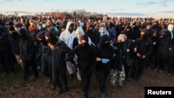 Activists demonstrate at Luetzerath, a village that is about to be demolished to allow for the expansion of the Garzweiler open-cast lignite mine of Germany's utility RWE, Germany, Jan. 8, 2023. 