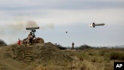 In this picture released by the official website of the Iranian Army on Dec. 30, 2022, a missile is launched in an annual drill in the coastal area of the Gulf of Oman and near the strategic Strait of Hormuz. (Iranian Army via AP)