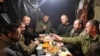 Ukrainian service members have their festive Christmas dinner, at an unknown location, Dec. 25, 2022. (Press Service of the General Staff of the Ukrainian Armed Forces/Handout via Reuters)